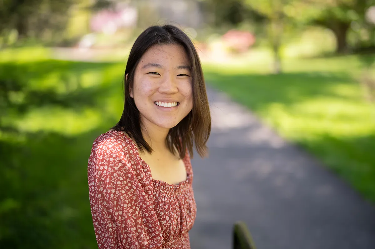 Lauren Park standing on outdoor path surrounded by green grass