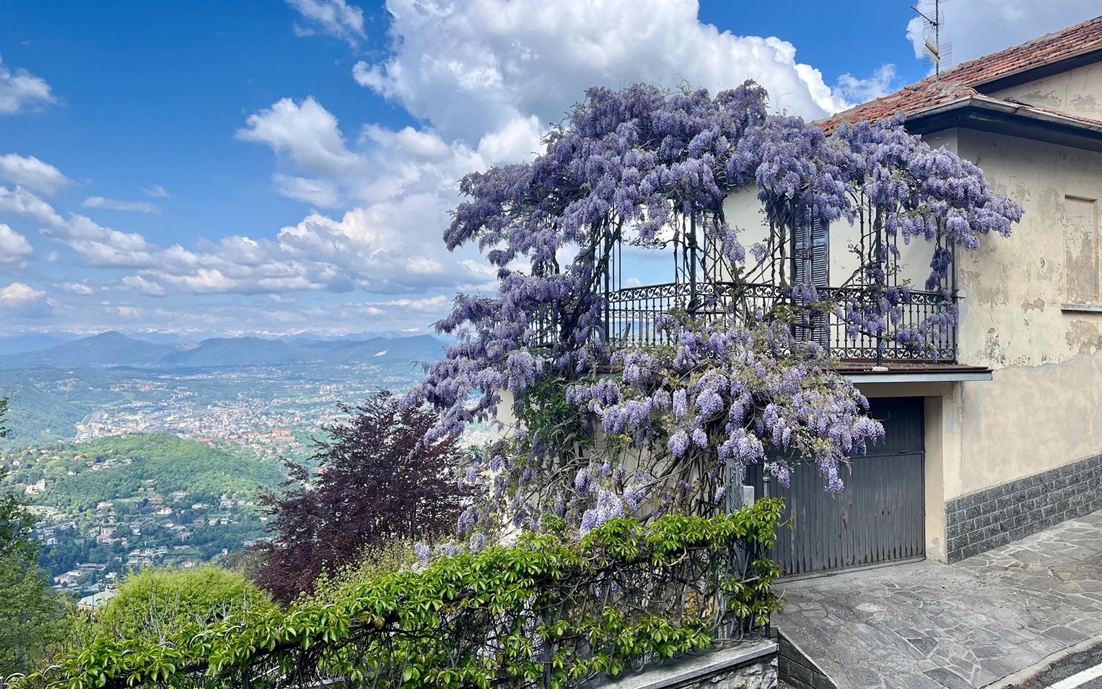 Flowers-covered building on mountain overlooking town