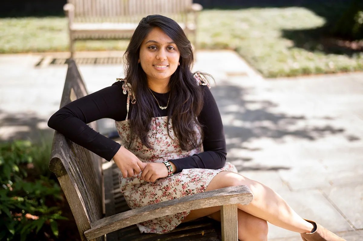 Yashvi Patel sitting on bench outside