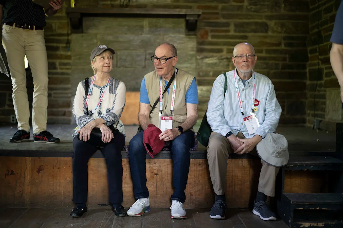 Three alumni sit on stage at empty Olde Club venue