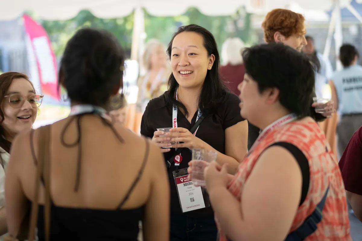 Alumni have conversation during outdoor reception