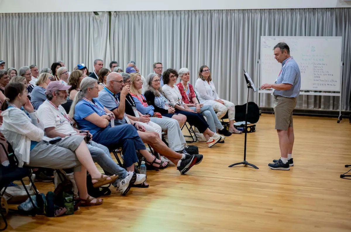 Alumni sit indoors for presentation