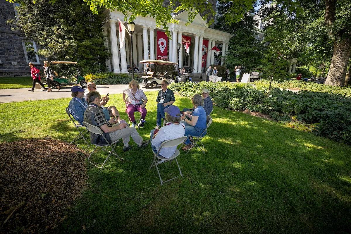 Alumni seated in circle on Parrish Beach