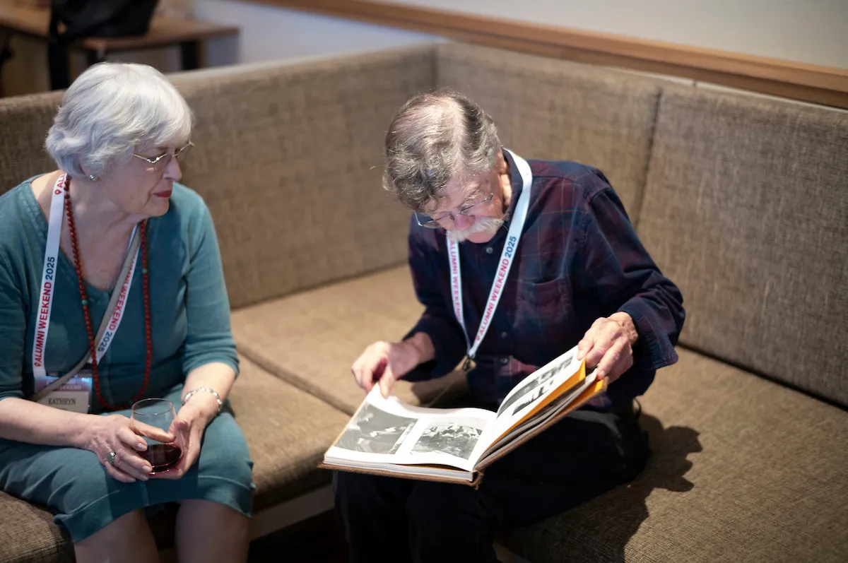 Two alumni look at yearbook