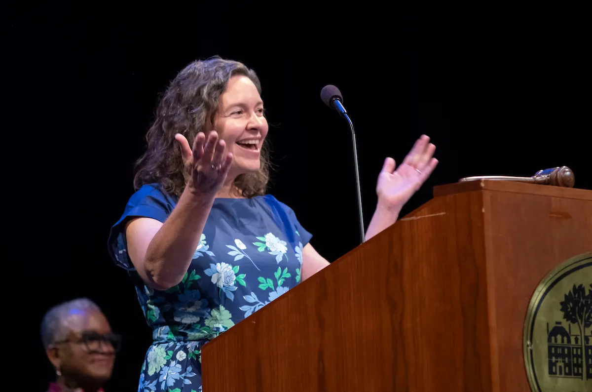 Person speaks at podium during collection