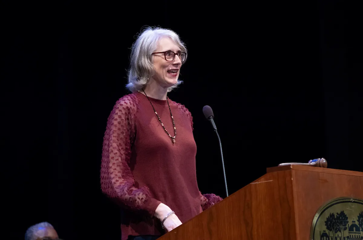 Person speaks at podium during collection