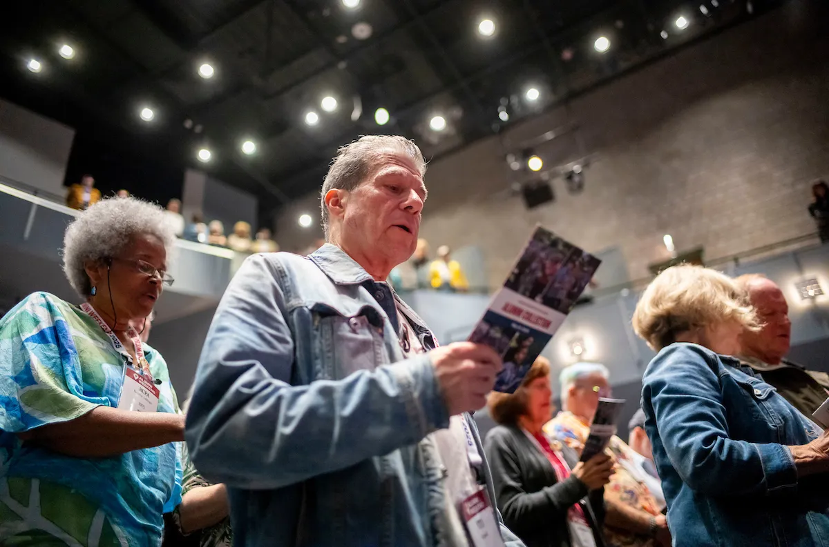 Alums sing during alma mater at collection