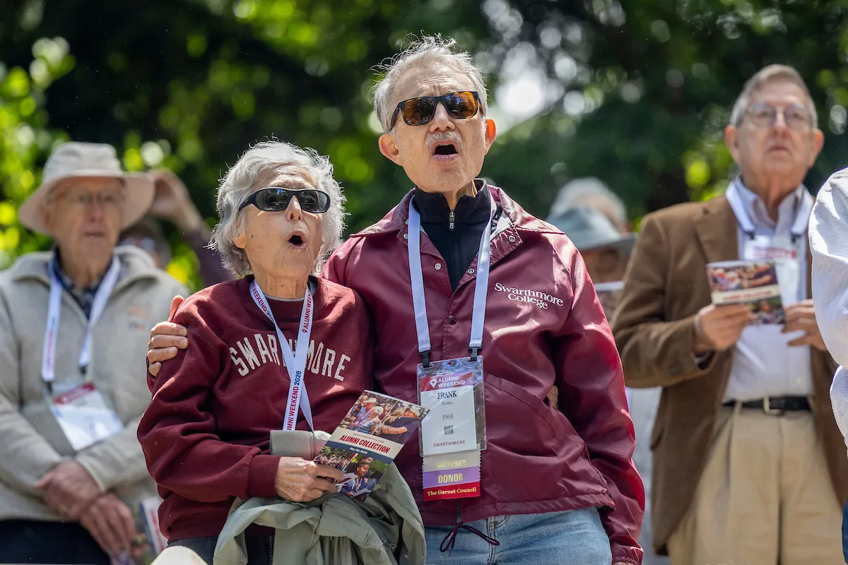 Alums in Swarthmore jackets sing alma mater