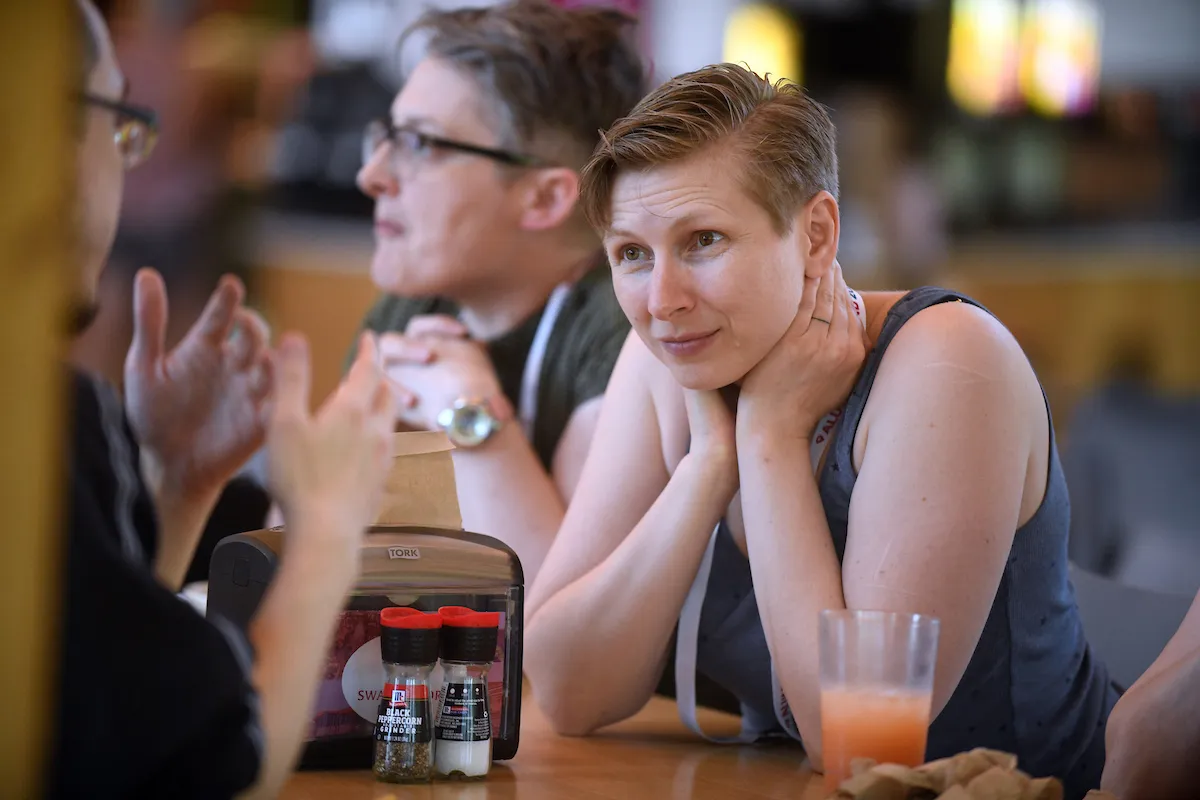 Alum listens attentively to conversation in dining center