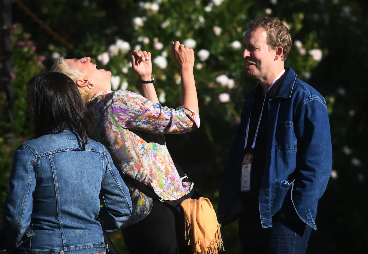 Alum laughs while having conversation outside