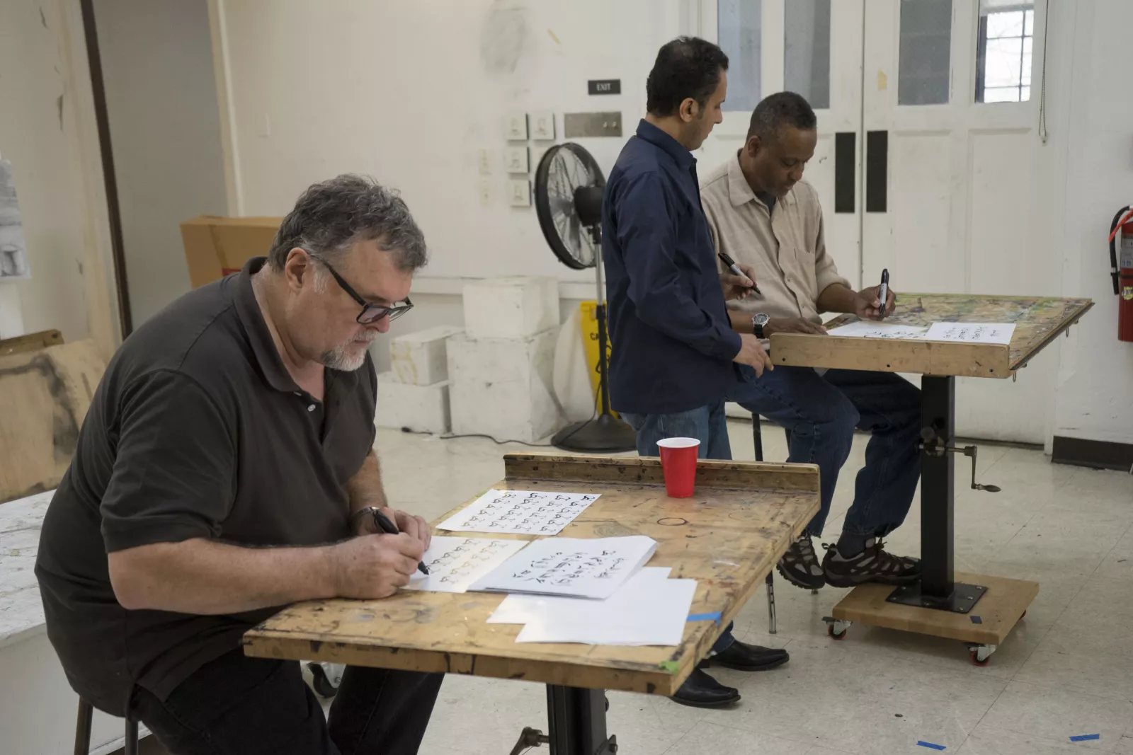 Professor Brian Meunier practices calligraphy