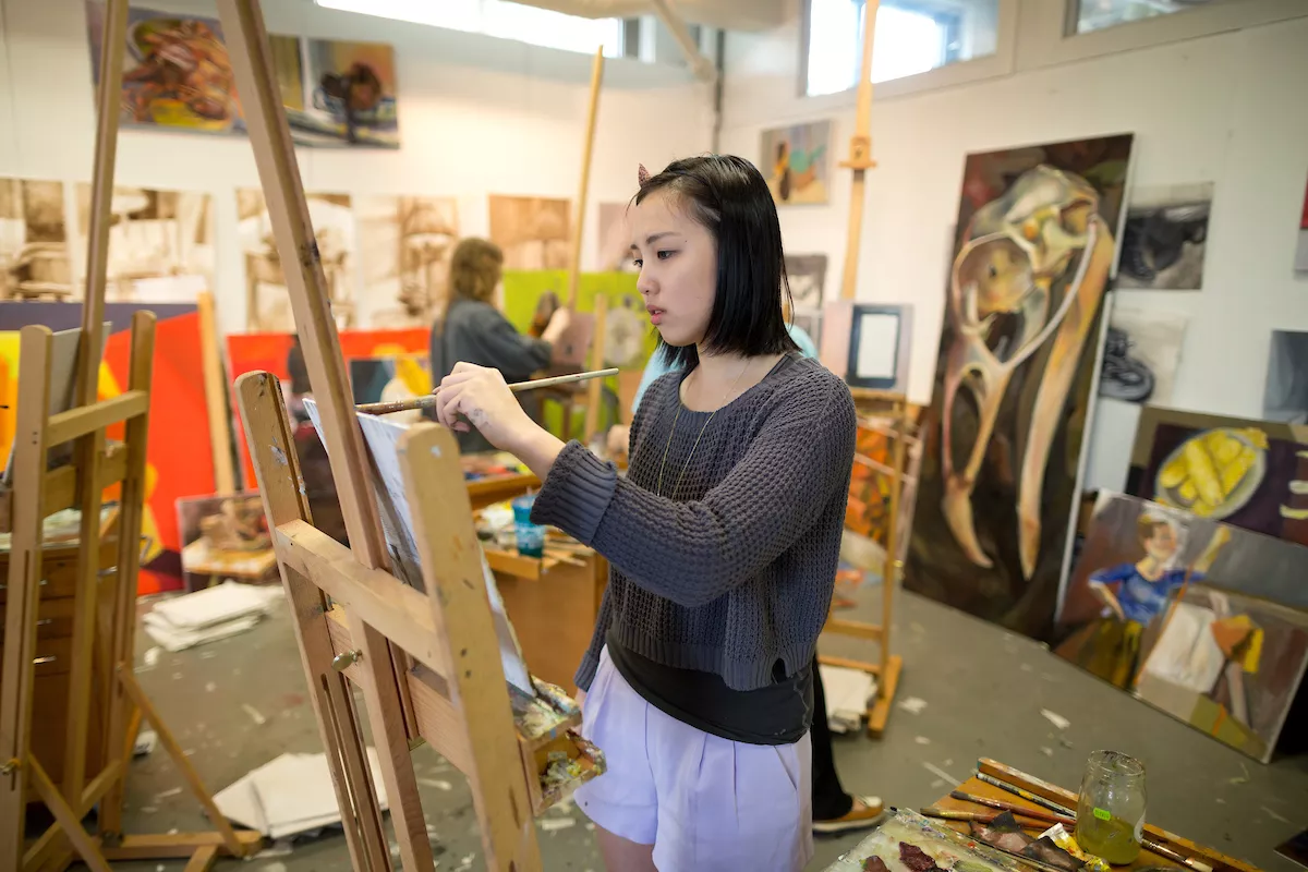 Beardsley Hall, Painting studio, student working.
