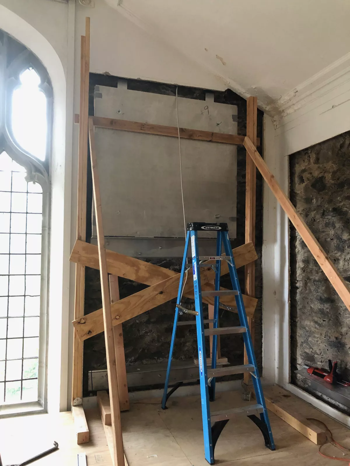 Wall preparation before the install of mural sections inside the Connie Hungerford Art Studio, Old Tarble.