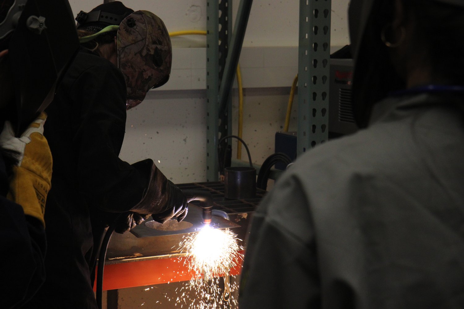 Student welding in the Sculpture II: Metal class.