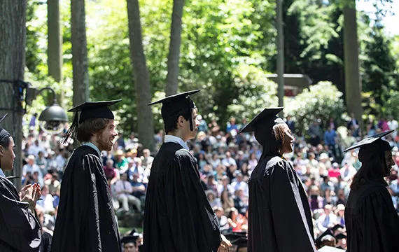 Students line up to receive their degrees