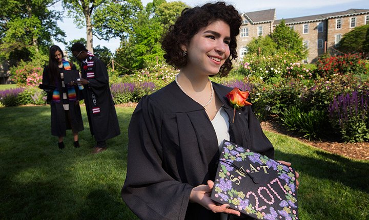 student showing off her mortar board