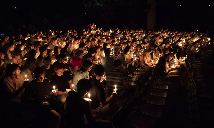 Students hold candles at Last Collection