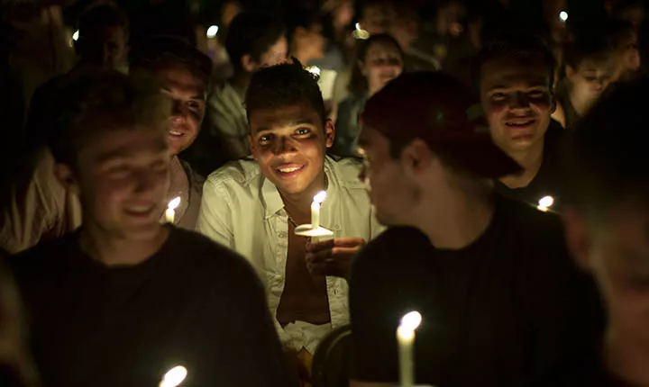 Students hold candles at Last Collection