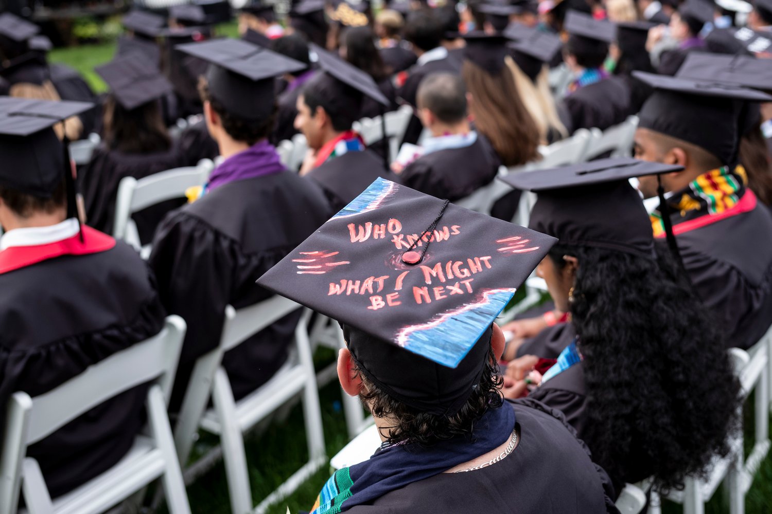 Students seated with graduation caps