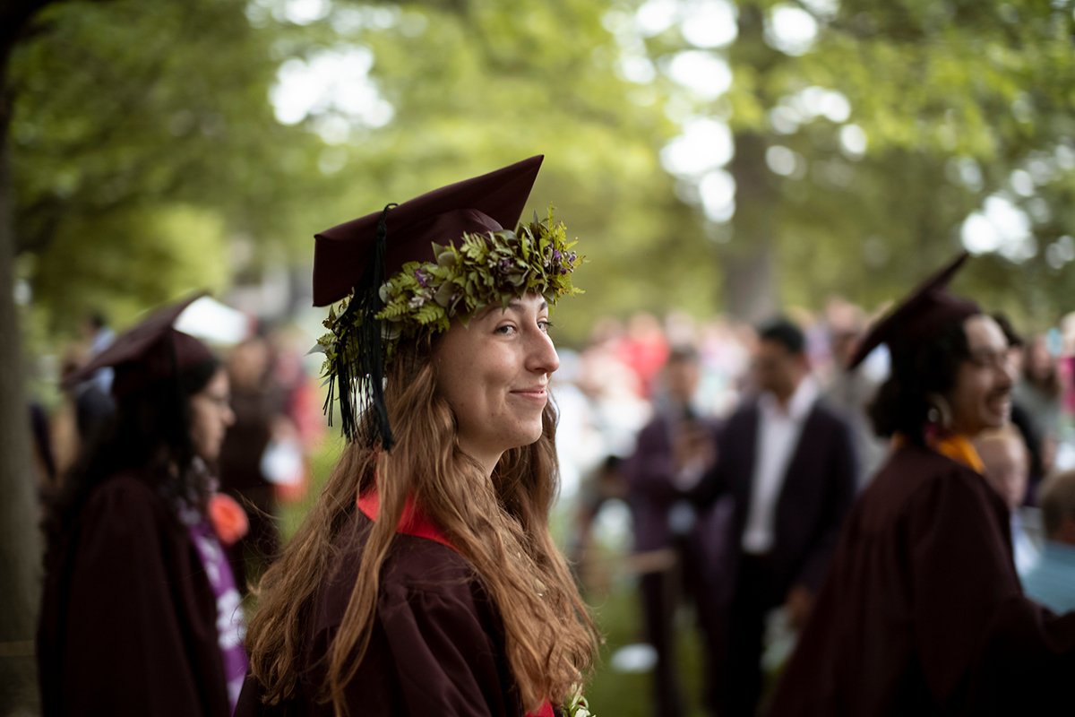 A student smiles in her cap and gown