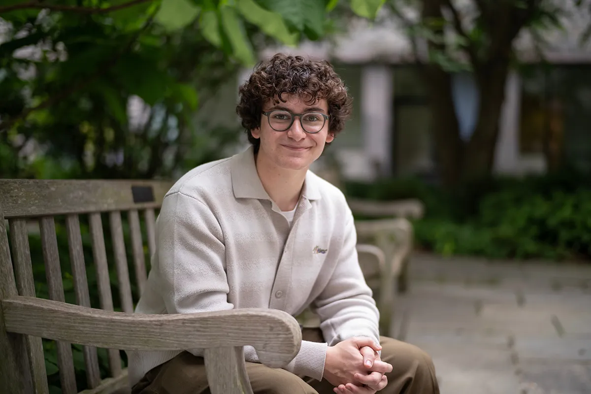 Daniel Khazanov sitting on bench outdoors
