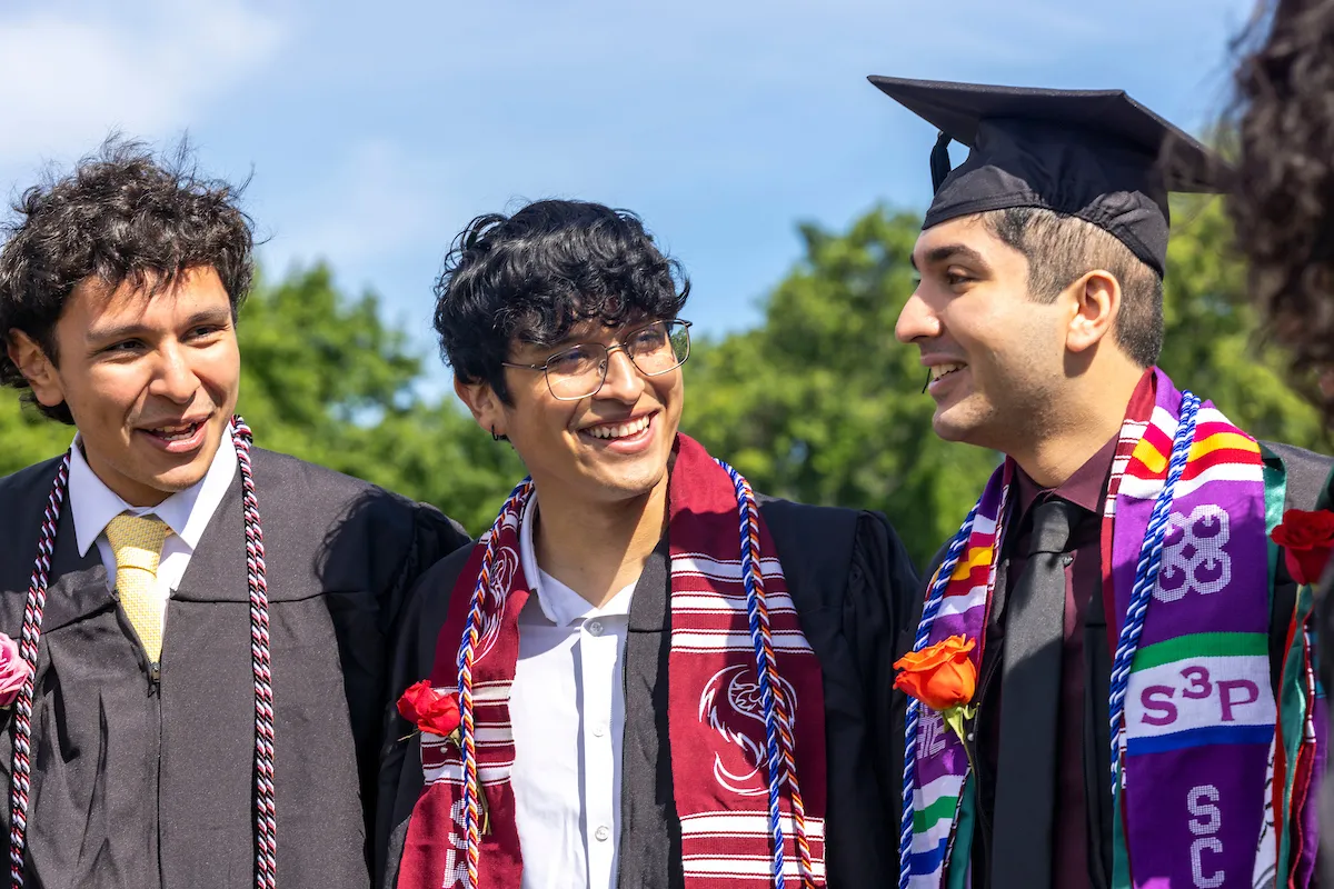 Group of students smiling before commencement ceremony