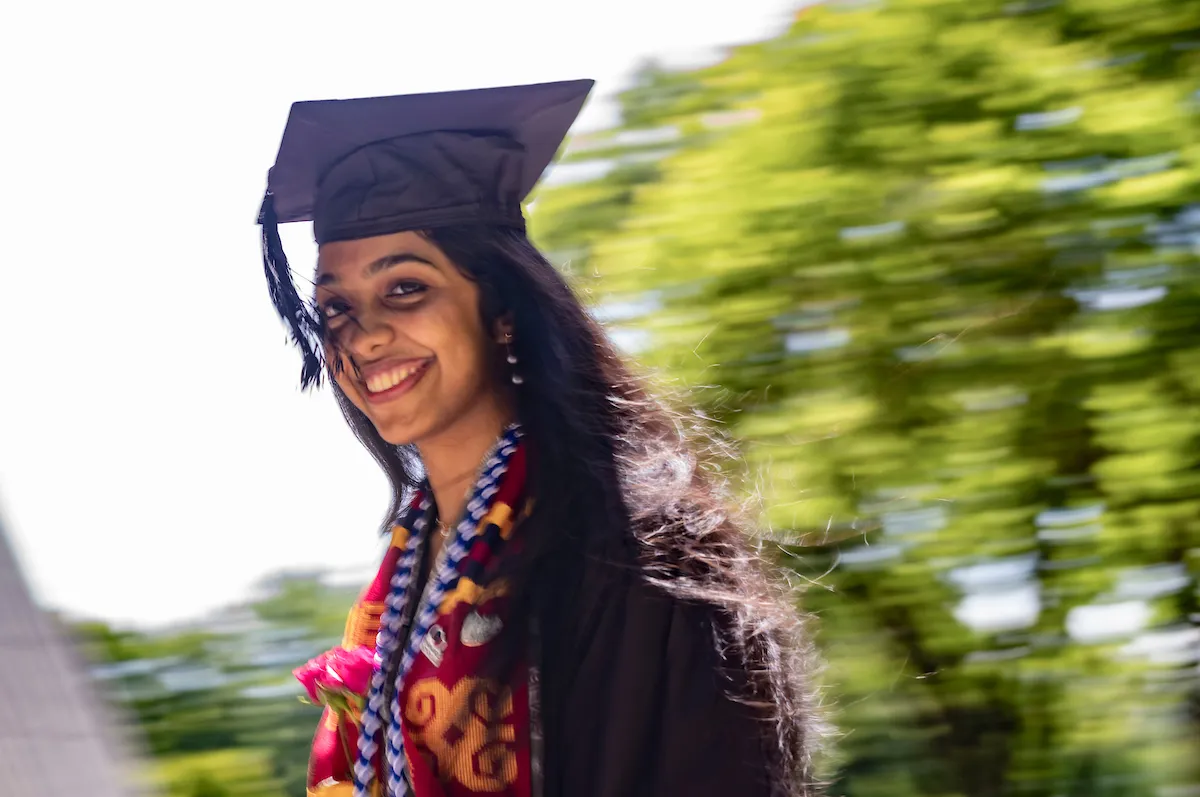Student walks during commencement procession