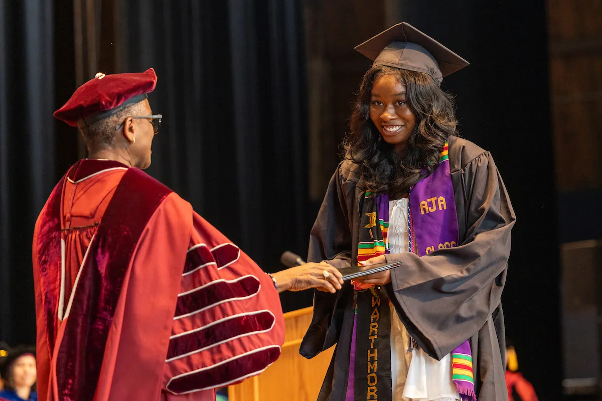student receives diploma at commencement