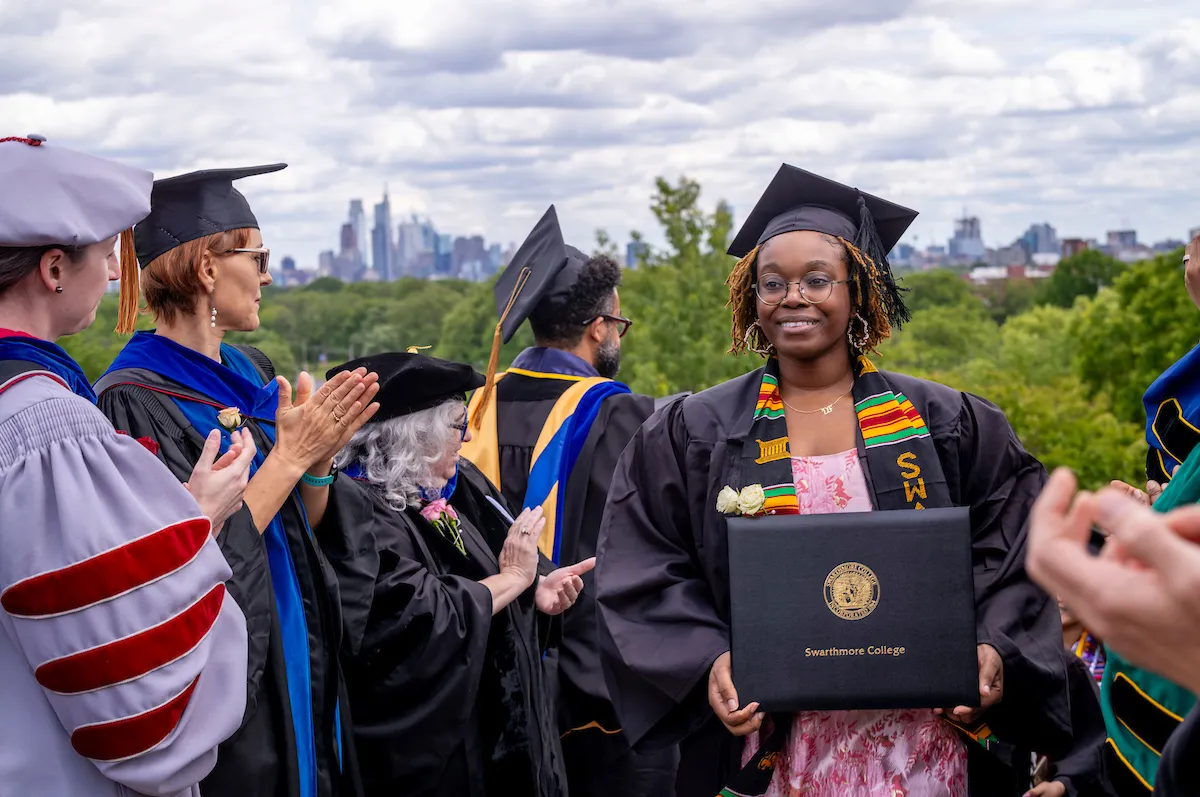 student with diploma after commencement