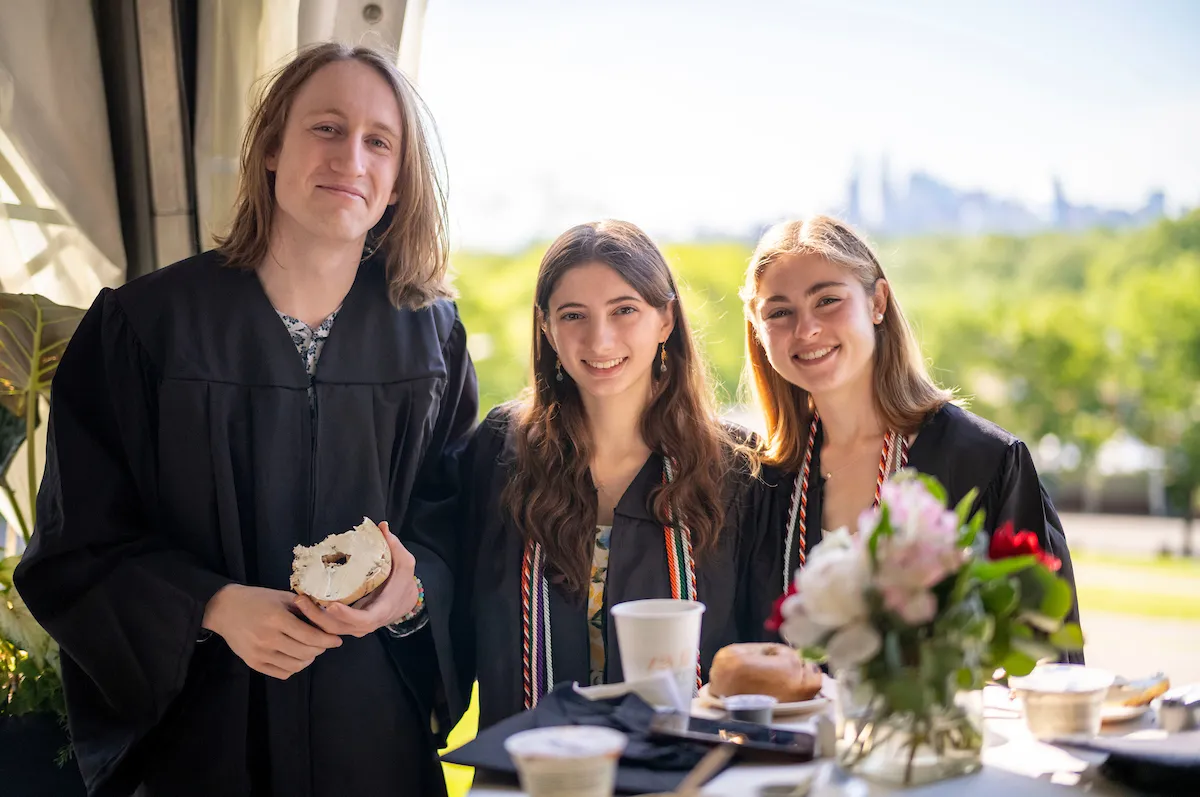 Three students eat breakfast before commencement ceremony
