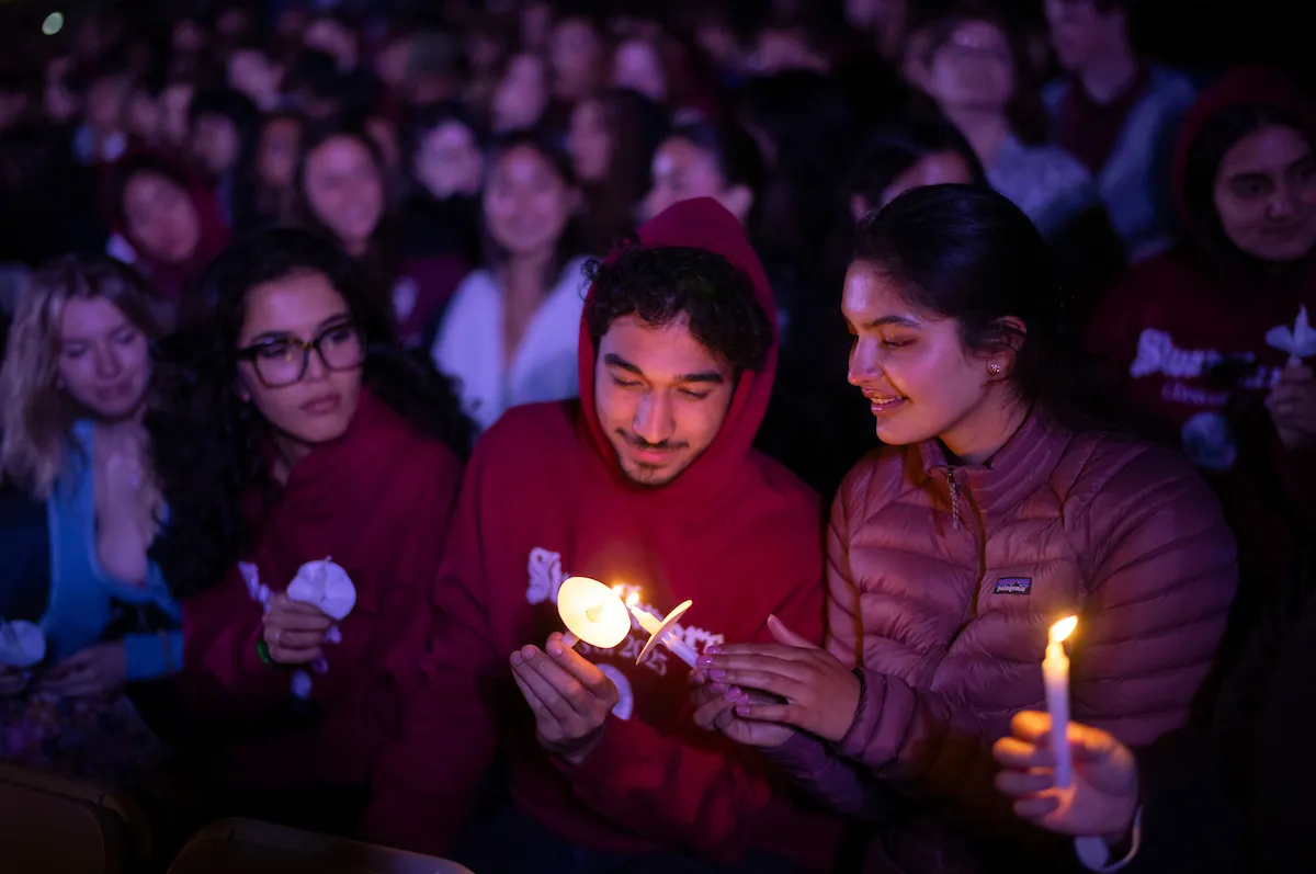 Students share candles at last collection