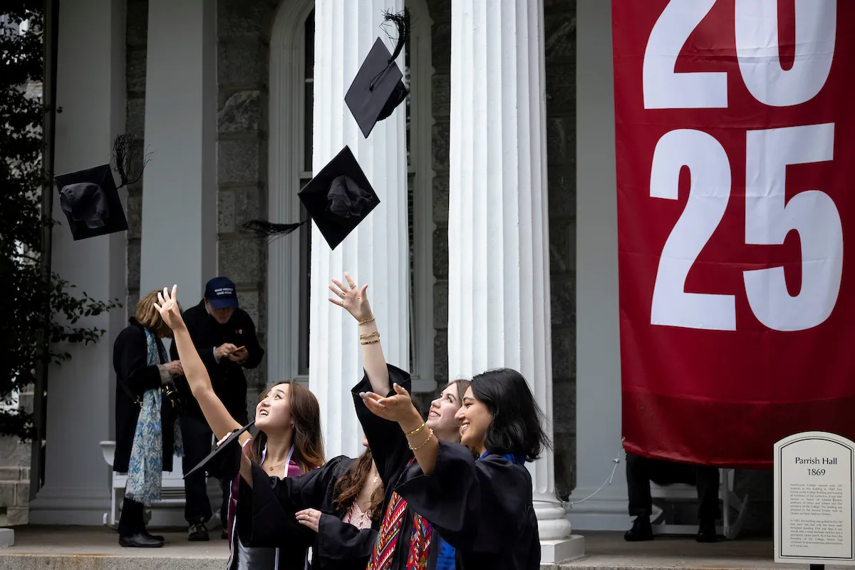 Students toss graduation caps in air