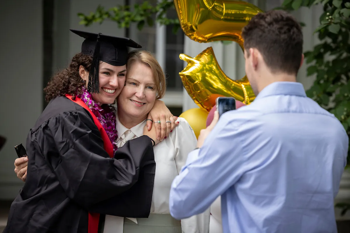 Student poses with family member after baccalaureate