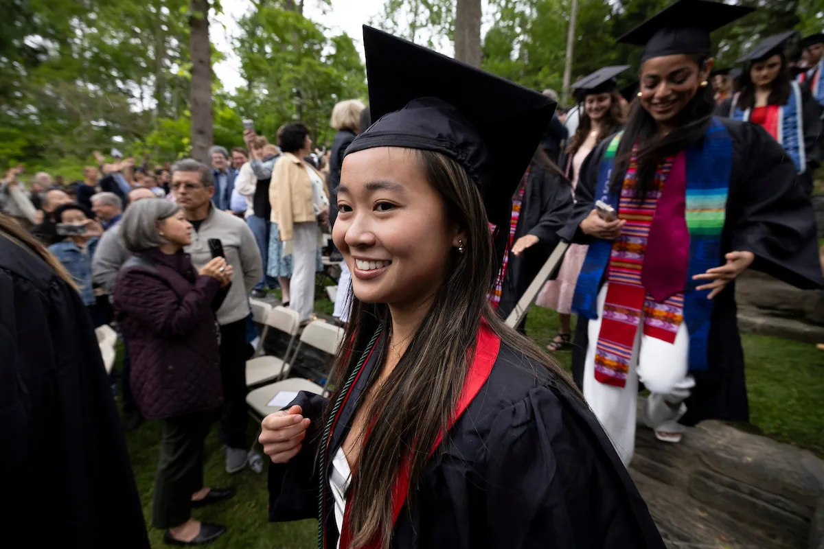 Students walk to Baccalaureate ceremony in scott outdoor amphitheater