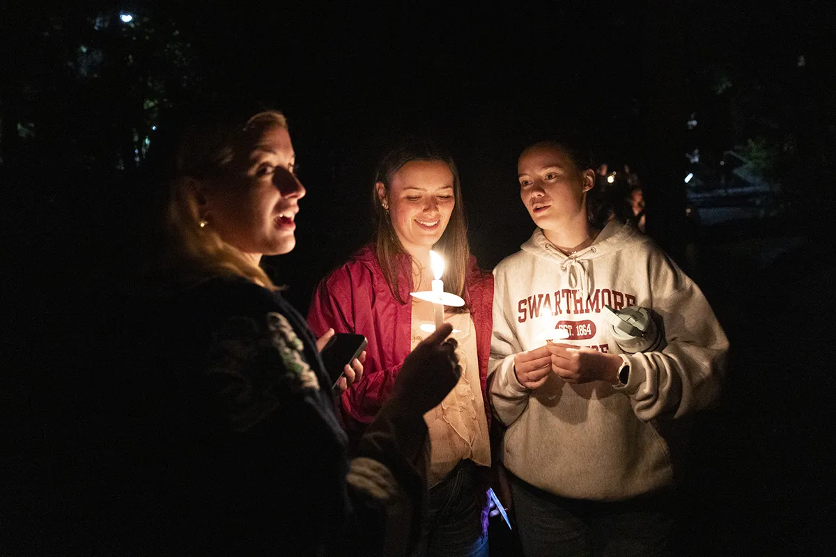 Students with candles convene for Last Collection ceremony