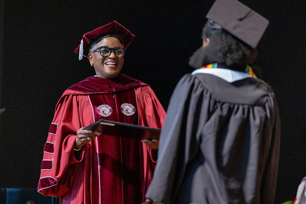 Val Smith with student at commencement