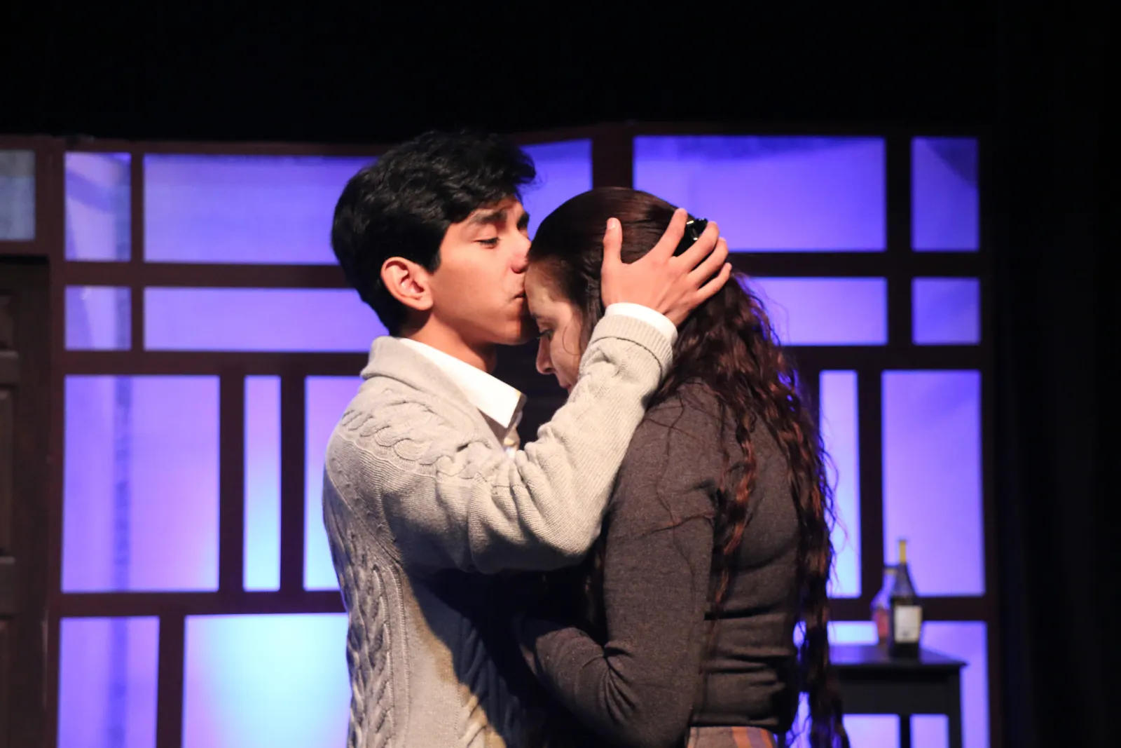 Daniel Oakes kisses Eva Nahass on the forehead.