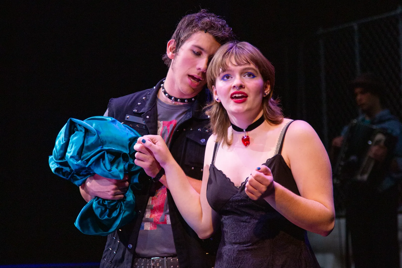 Polly Peachum looks out at the moon over Soho while Mack holds her hand and whispers in her ear