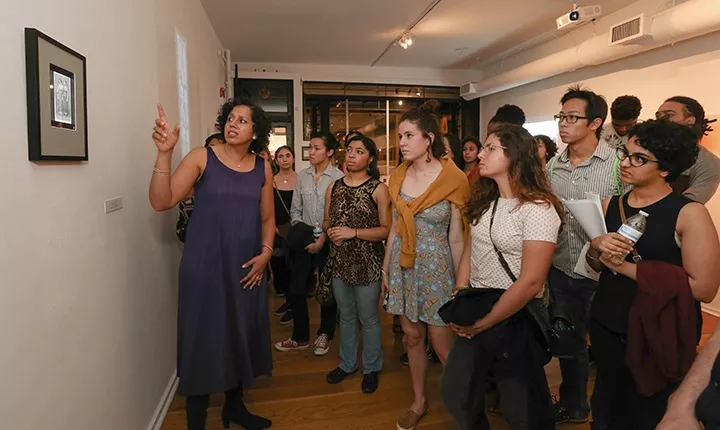 Associate Professor of English Literature Bakirathi Mani with students