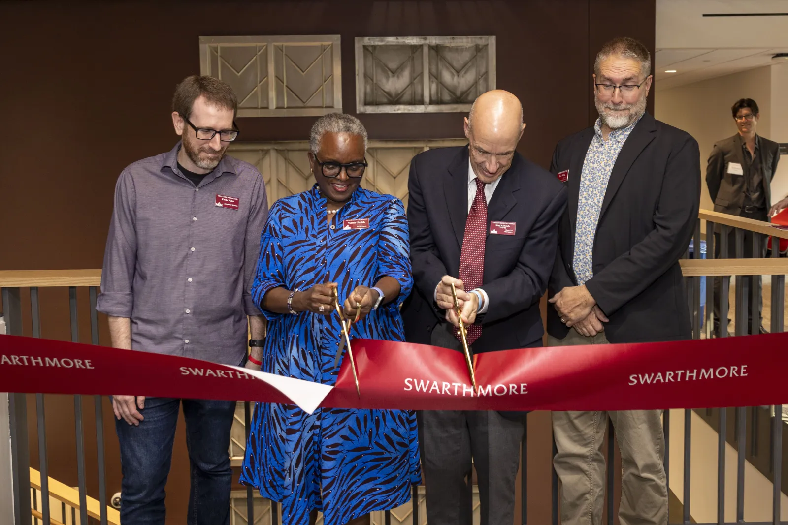 President Smith and Koof Kalkstein cut a red ribbon in Martin Hall while Bob Rehak and Kevin Webb look on