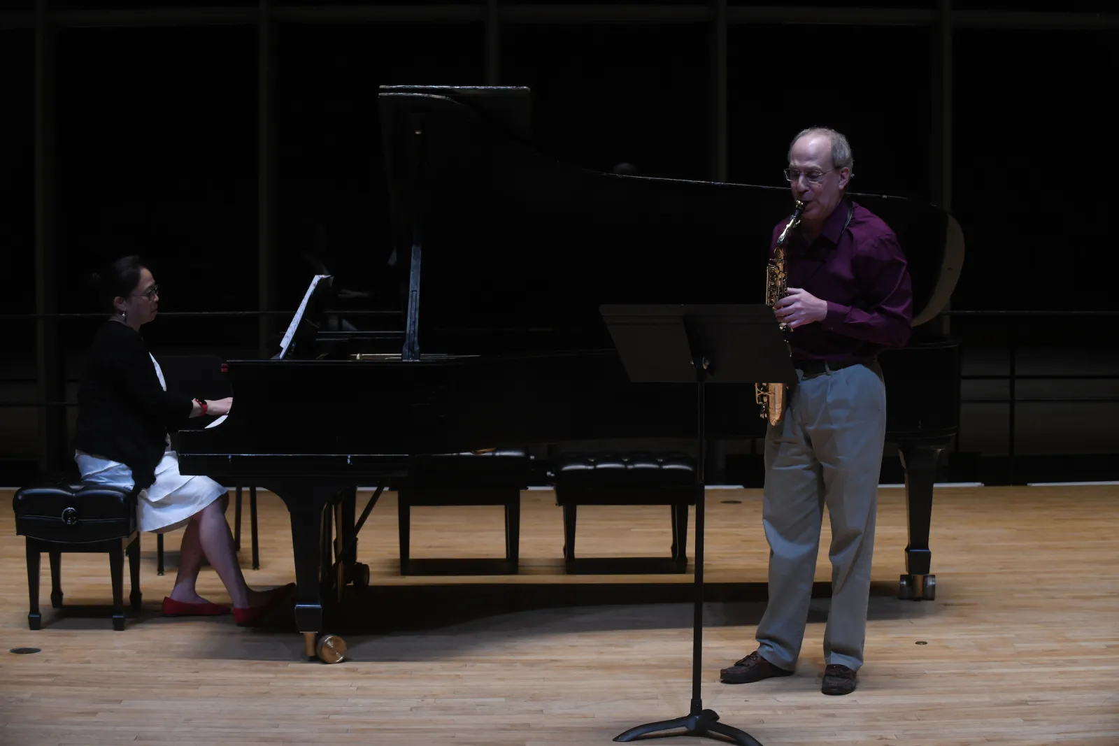 Person plays saxophone on stage