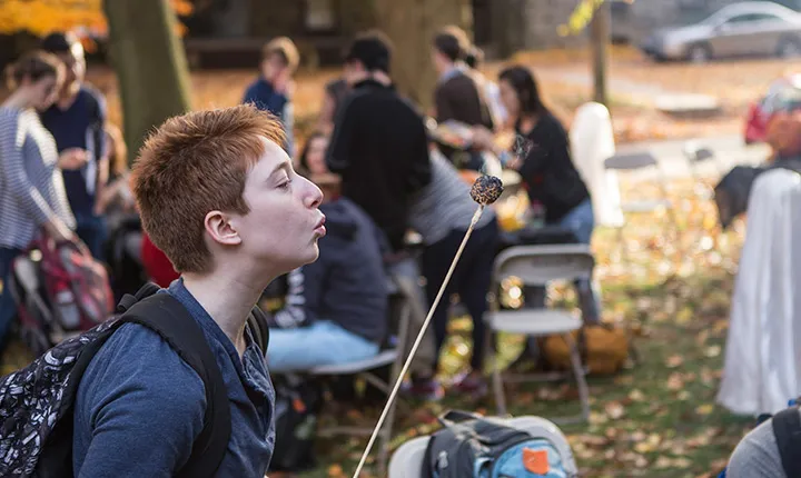 A student enjoys a s'more