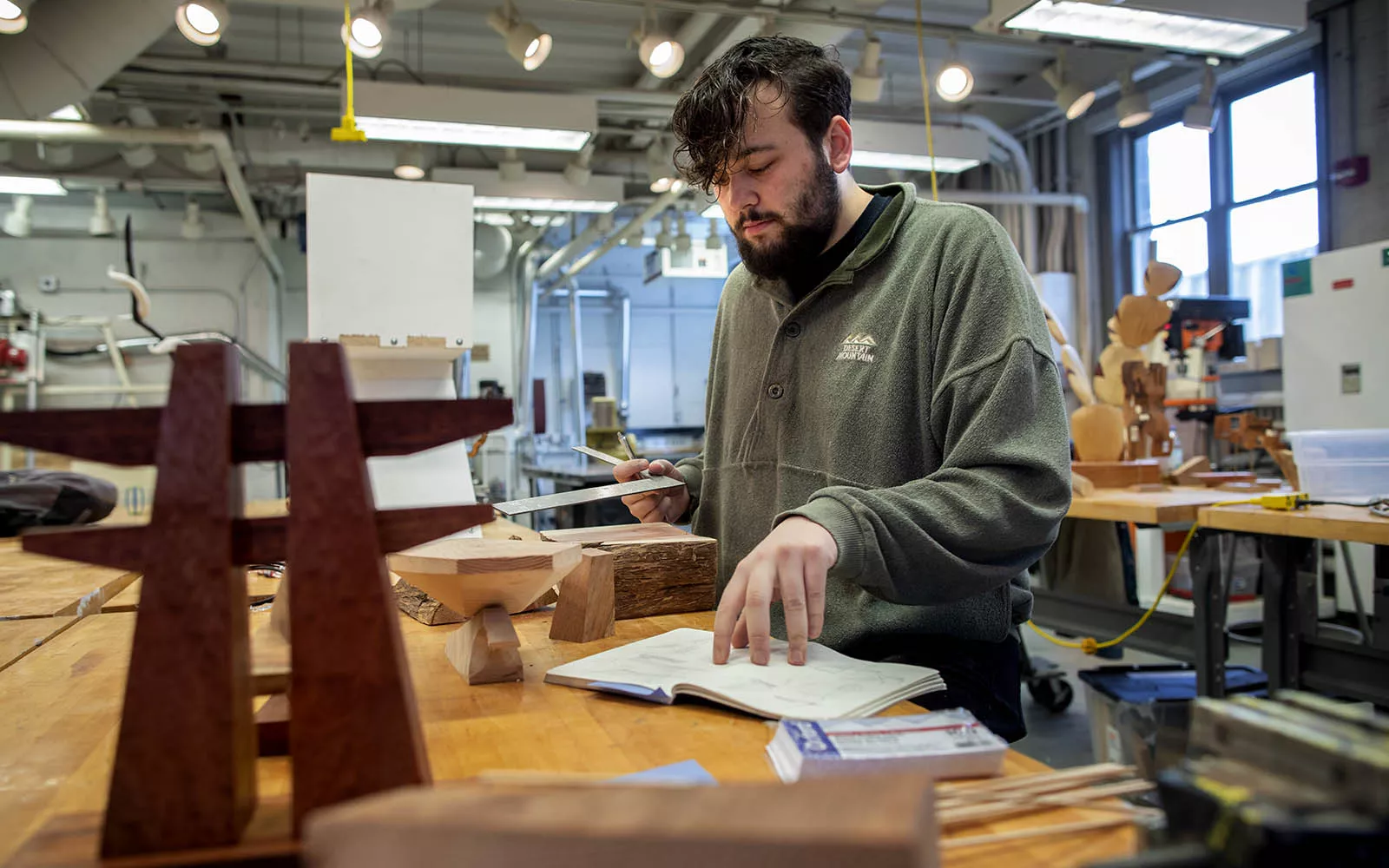 Student looking at notes while in art studio