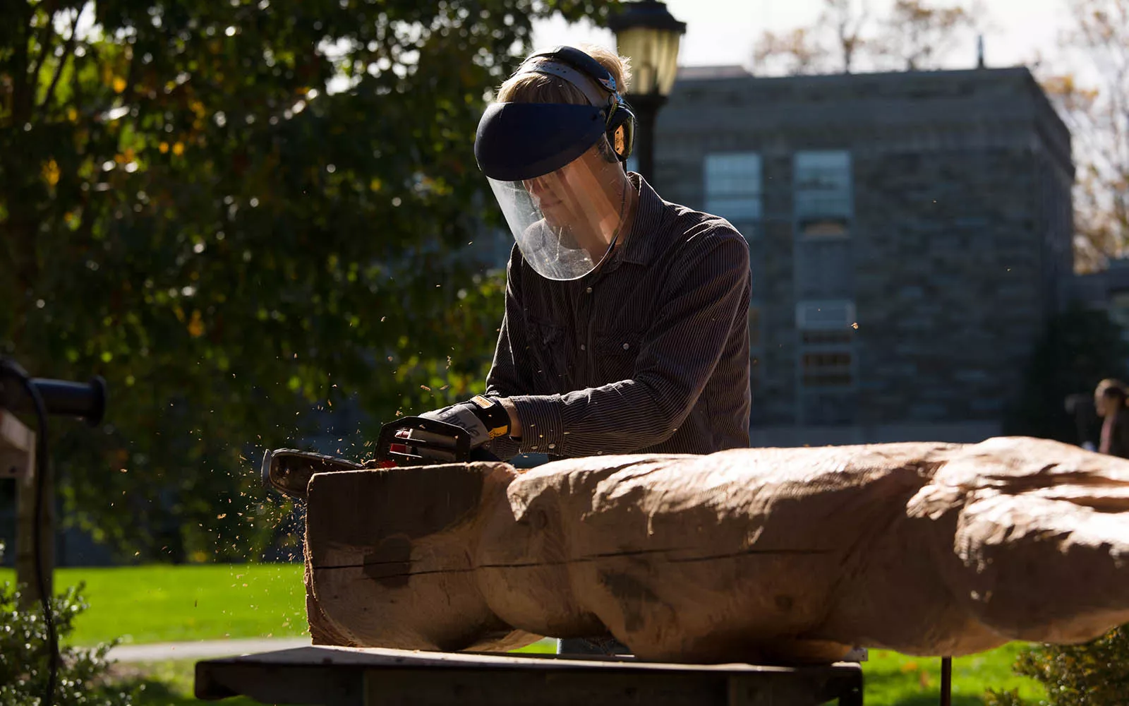Student sculpting wood