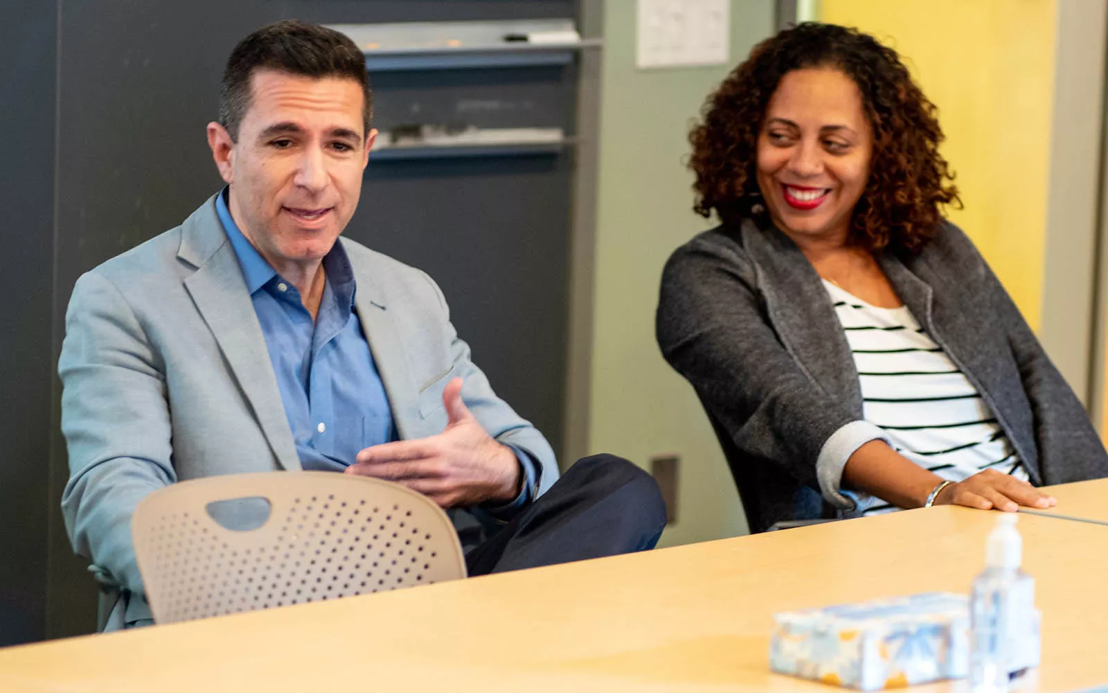Two people sitting at table in the Lang Center