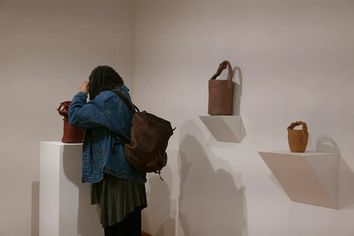 Visitor examines pieces in List Gallery exhibit