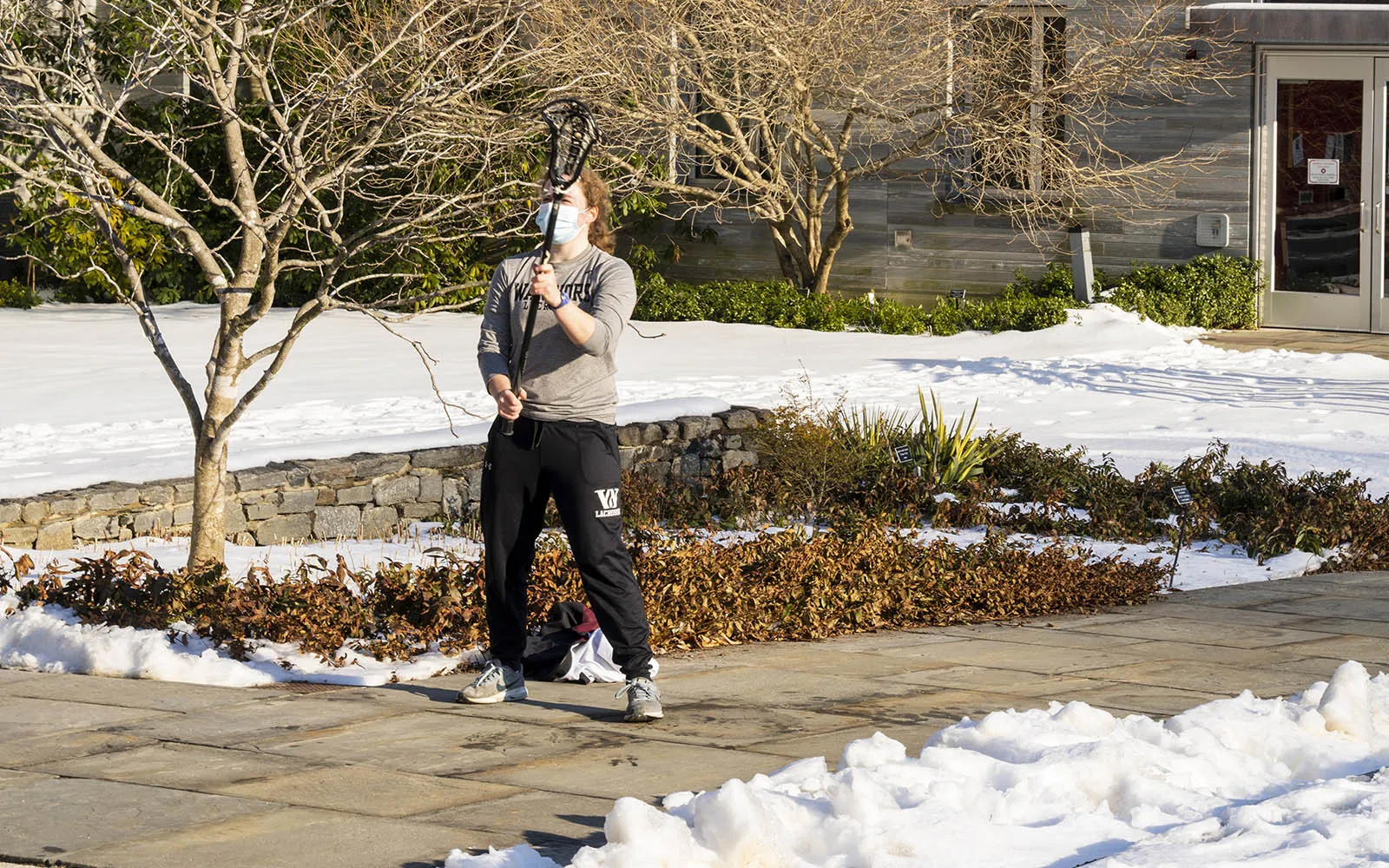student practicing lacrosse