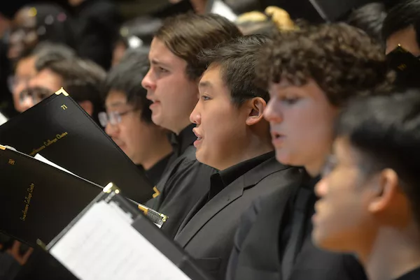 Group of students singing on stage