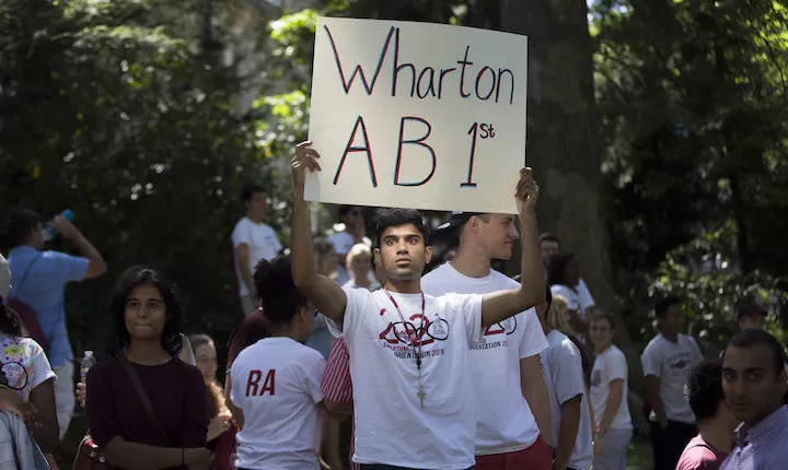 student with Wharton sign