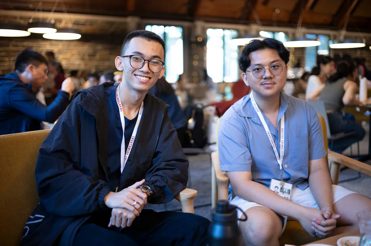 Two international students sit in Sharples Commons